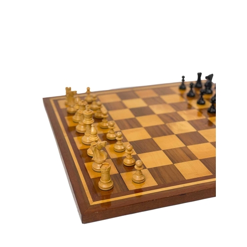 30 - A boxwood and ebony chess set. In a mahogany box, another chess set, and an inlaid chess board.