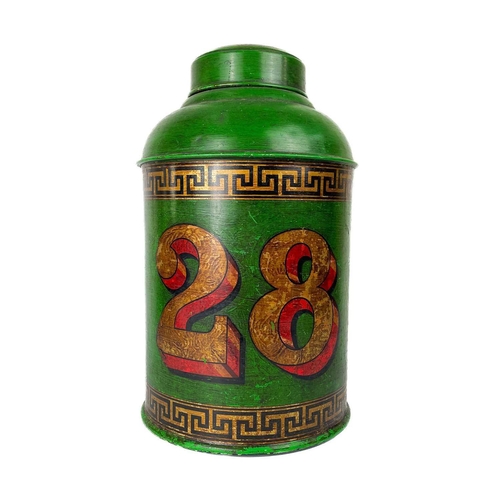 33 - A large tin display tea caddy. In green number '28' and greek key borders, height 45cm diameter 26cm