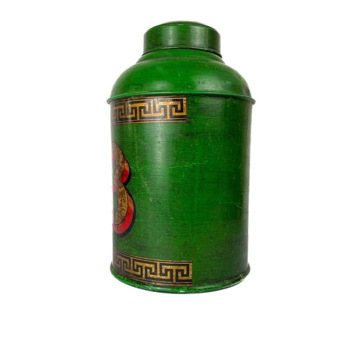 33 - A large tin display tea caddy. In green number '28' and greek key borders, height 45cm diameter 26cm