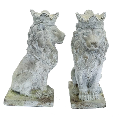 347 - A pair of reconstituted stone lions. With crowns, height 35cm,depth 19cm, width 13cm.