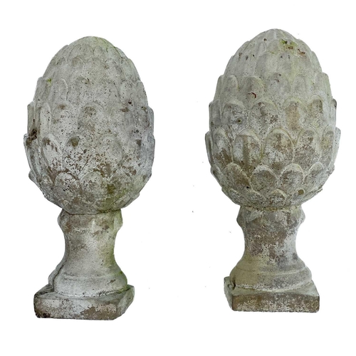 348 - A pair of white ceramic cones of naturalistic form. Together with a pair of reconstituted stone cone... 