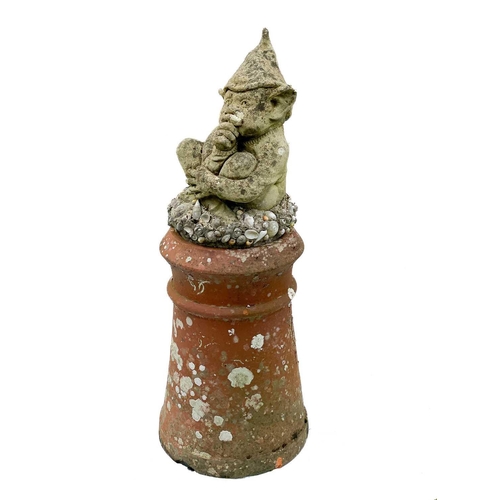 351 - A pair of reconstituted stone Cornish Piskies on shell encrusted bases. Mounted on clay chimney pots... 