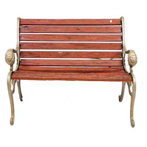 360 - A pair of cast iron garden benches. With cast iron bench ends painted gold and lion mask detail, wid... 