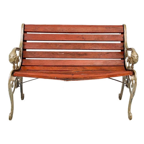 360 - A pair of cast iron garden benches. With cast iron bench ends painted gold and lion mask detail, wid... 