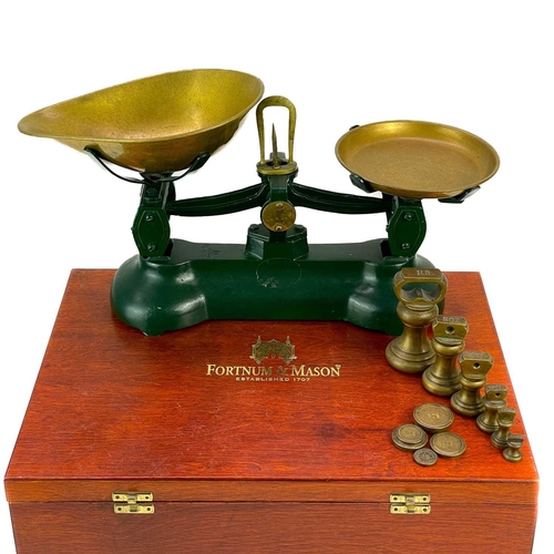 41 - A set of kitchen balance scales. Together with a set of postage scales contained in a Fortnum and ma... 