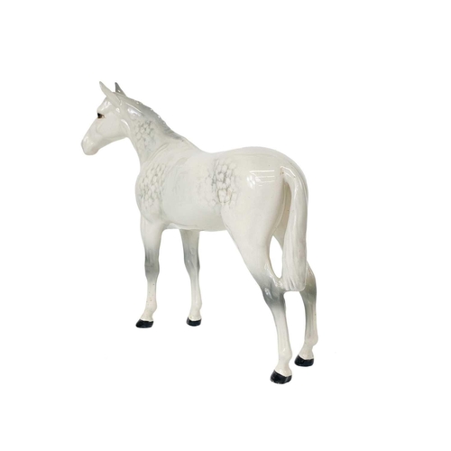 413 - A Beswick Pottery dappled grey horse. Label and stamp marks, height 20.5cm