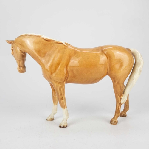 414 - A Beswick Pottery Palomino mare. Height 14cm, together with a Beswick Pottery horse both in gloss. (... 