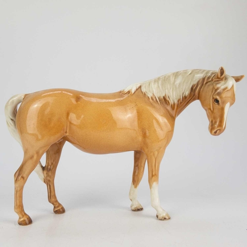 414 - A Beswick Pottery Palomino mare. Height 14cm, together with a Beswick Pottery horse both in gloss. (... 