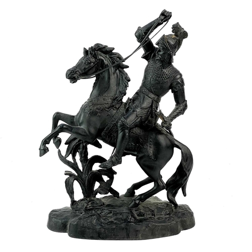 46 - A spelter sculpture of a knight on horseback. Height 44cm, length 41cm.