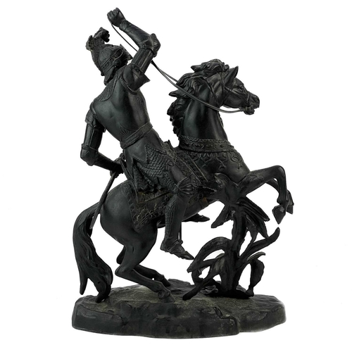 46 - A spelter sculpture of a knight on horseback. Height 44cm, length 41cm.