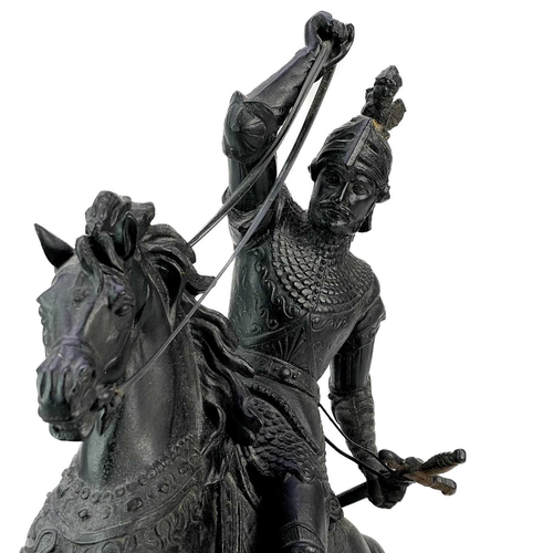 46 - A spelter sculpture of a knight on horseback. Height 44cm, length 41cm.