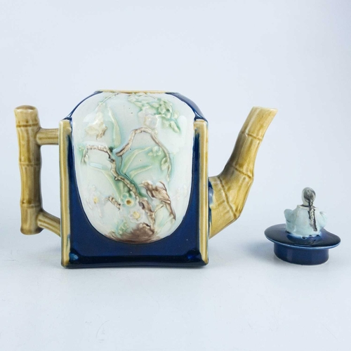 487 - A Victorian majolica teapot and cover. Circa 1870, with simulated bamboo spout and handle, moulded C... 