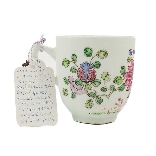 497 - An early Bow coffee cup. Painted in a Famille Rose pallette with a flowering peony, height 6cm.