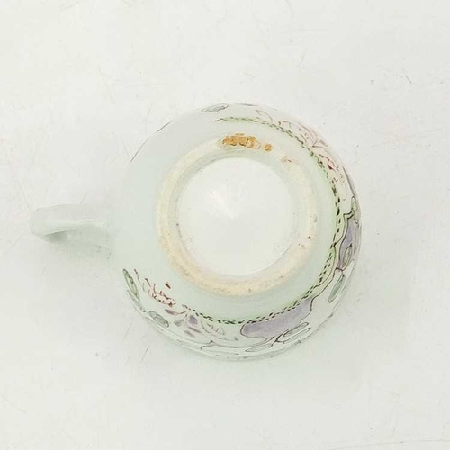 497 - An early Bow coffee cup. Painted in a Famille Rose pallette with a flowering peony, height 6cm.