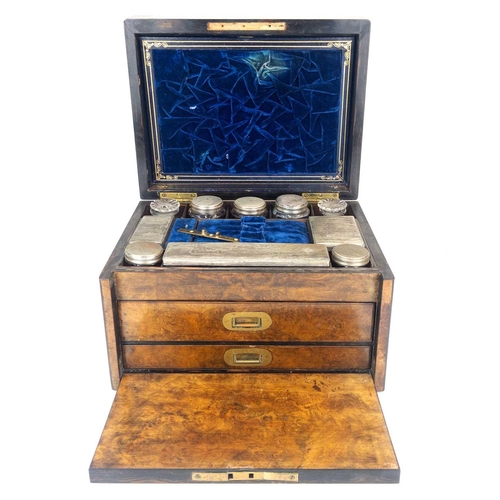 50 - A Victorian burr walnut fitted dressing case. The jars and bottles with plated mounts, the drop-down... 