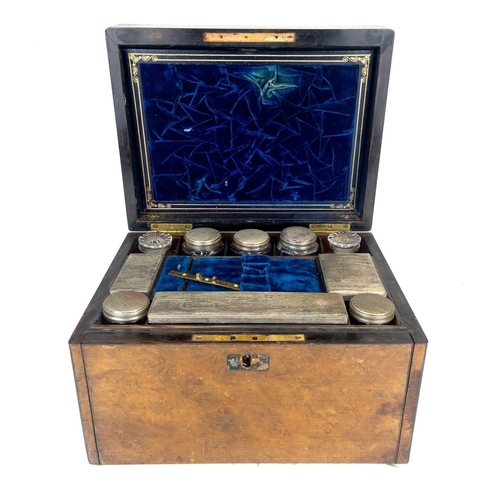 50 - A Victorian burr walnut fitted dressing case. The jars and bottles with plated mounts, the drop-down... 