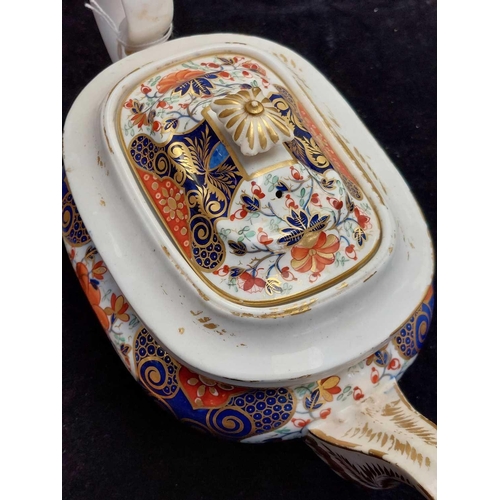 505 - A Bloor Derby circular porcelain teapot and cover. Circa 1820, painted and gilt in the Imari palette... 