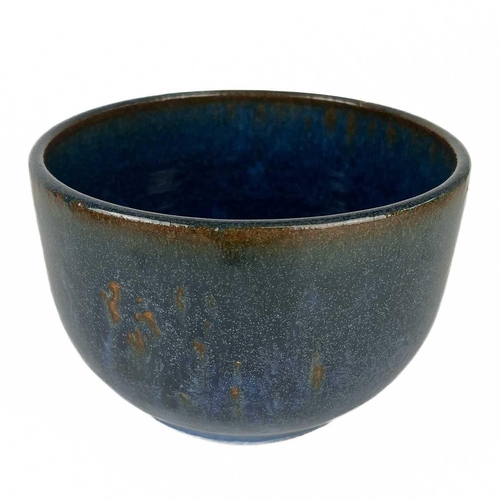 515 - A collection of studio pottery. To include; A bowl with speckled glaze, signed Micki Schloessingk di... 