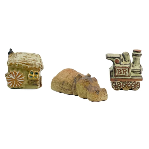 524 - A large collection of Tremar pottery. To include four money boxes, two moddeled as trains, one a tuc... 