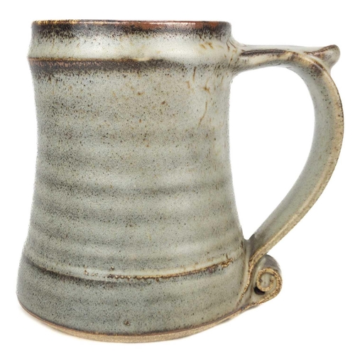 525 - A Leach pottery standard ware mug or tankard. The handle with scroll terminal, impressed mark, heigh... 