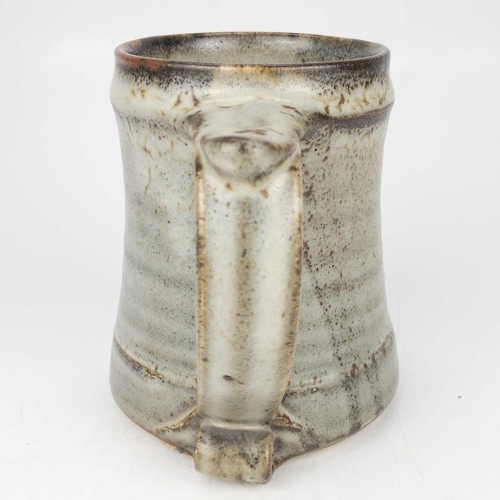 525 - A Leach pottery standard ware mug or tankard. The handle with scroll terminal, impressed mark, heigh... 