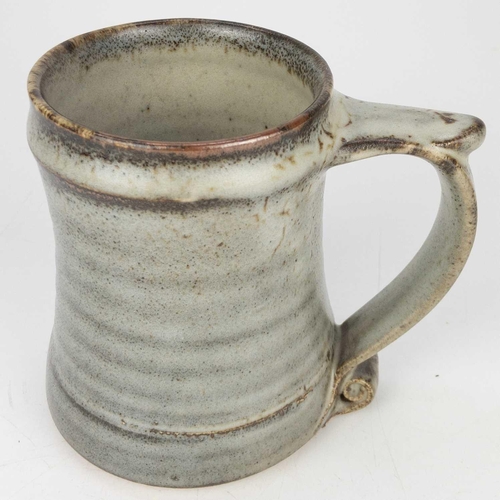 525 - A Leach pottery standard ware mug or tankard. The handle with scroll terminal, impressed mark, heigh... 