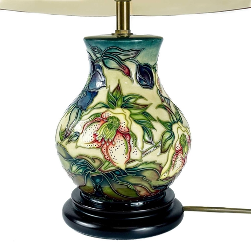 528 - A Moorcroft Pottery Ashwood Hellebore table lamp, by Nicola Slaney. Height including shade 45cm.