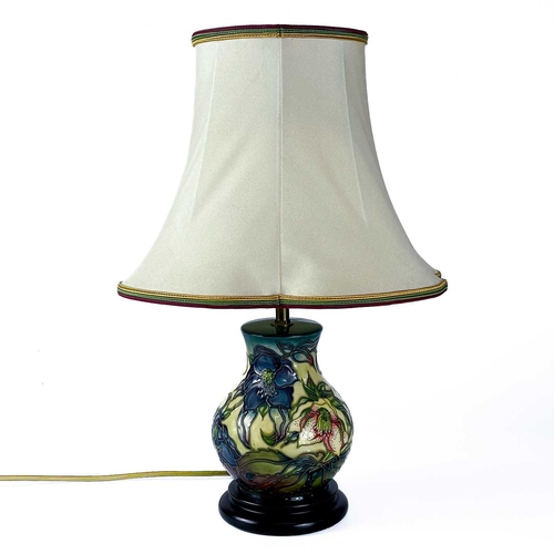 528 - A Moorcroft Pottery Ashwood Hellebore table lamp, by Nicola Slaney. Height including shade 45cm.