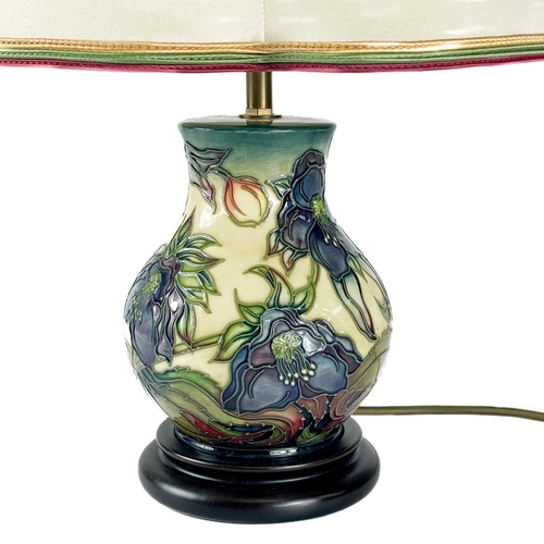 528 - A Moorcroft Pottery Ashwood Hellebore table lamp, by Nicola Slaney. Height including shade 45cm.