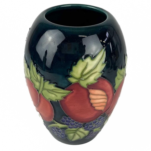 533 - A Moorcroft Pottery Snowdrop twin handled vase. M.C.C marks, height 15cm, together with a Moorcroft ... 