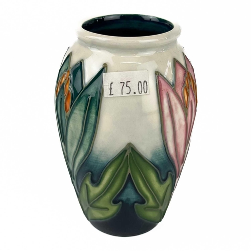 533 - A Moorcroft Pottery Snowdrop twin handled vase. M.C.C marks, height 15cm, together with a Moorcroft ... 