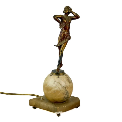 54 - An art deco figural lamp base. Gilt metal and a hollow sphere base, Height 34cm.