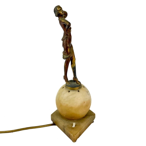 54 - An art deco figural lamp base. Gilt metal and a hollow sphere base, Height 34cm.