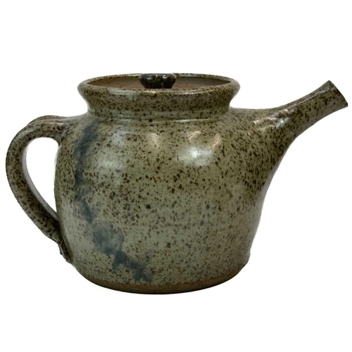 546 - A studio pottery tea pot. In a green glaze with bright orange interior, height including handle 27cm... 