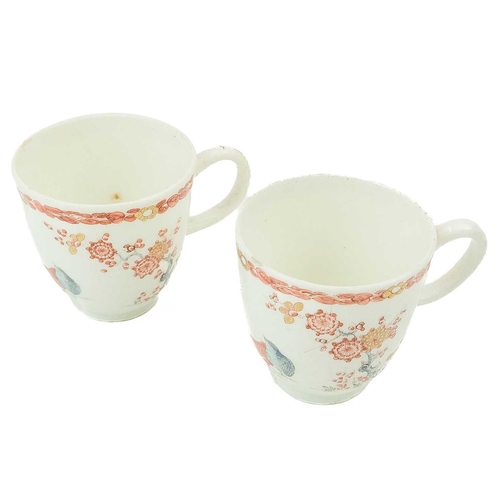 560 - A pair of Bow Kakiemon palette two Quail pattern coffee cups. Of diminutive size, height 5.5cm.