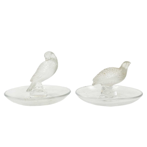 562 - A Lalique glass pin tray with a Quail. Signed Lalique France diameter 9.5cm, together with another L... 