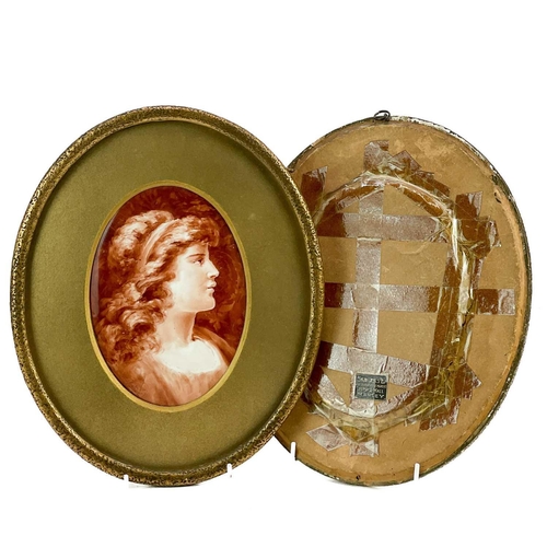 568 - A pair of late Victorian oval painted porcelain portrait plaques. Each with a monochrome female bust... 