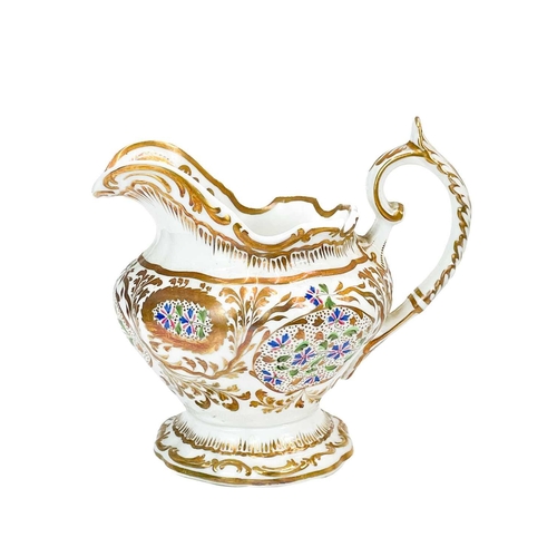 579 - A Copeland & Garrett tea and coffee service. Circa 1830, painted with speedwell and ornate gilt foli... 