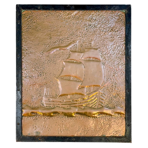 58 - An Arts and Crafts copper panel. Repousse decorated with a two-masted ship, in an iron surround, 63X... 