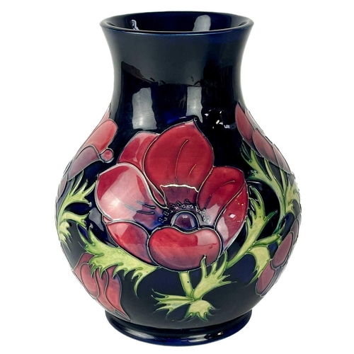 582 - A Moorcroft Pottery Anemone vase. Painters L.K. (Lorraine Knowles) initials, height 23cm, together w... 