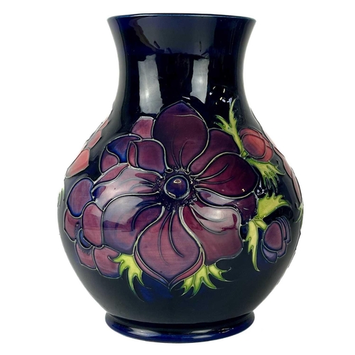 582 - A Moorcroft Pottery Anemone vase. Painters L.K. (Lorraine Knowles) initials, height 23cm, together w... 