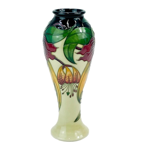 595 - A Moorcroft Pottery inverted baluster vase. Anna Lily pattern with box, height 27cm.