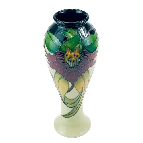 595 - A Moorcroft Pottery inverted baluster vase. Anna Lily pattern with box, height 27cm.