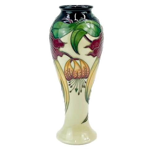 595 - A Moorcroft Pottery inverted baluster vase. Anna Lily pattern with box, height 27cm.