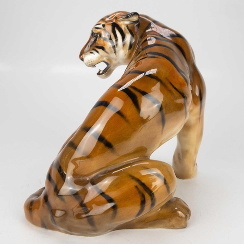 596 - A Royal Doulton figure of a seated tiger HN 912. Designed by Charles Noke, impressed and printed mar... 