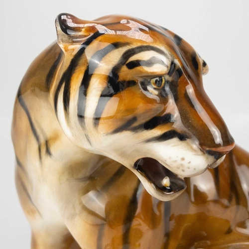 596 - A Royal Doulton figure of a seated tiger HN 912. Designed by Charles Noke, impressed and printed mar... 