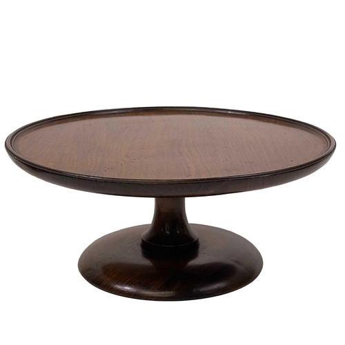 60 - An early 20th century walnut Lazy Susan. The rotating top raised on a turned column support and dome... 