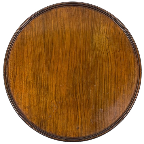 60 - An early 20th century walnut Lazy Susan. The rotating top raised on a turned column support and dome... 