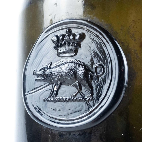 602 - An 18th century sealed wine bottle, crested Edgcumbe. The olive green bottle with a seal incorporati... 