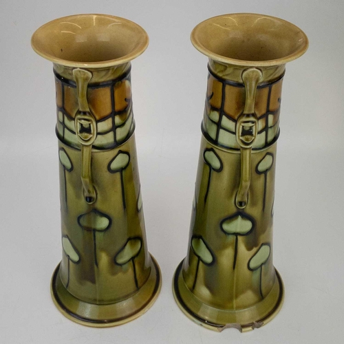 606 - A pair of Minton Secessionist vases. With strap handles, and tube-lined Art Nouveau decoration, shap... 